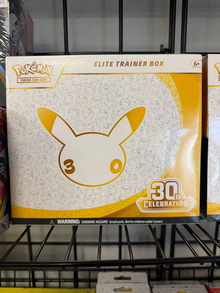 Pokémon 30th Celebration Elite Trainer Box on a shelf at Omni
